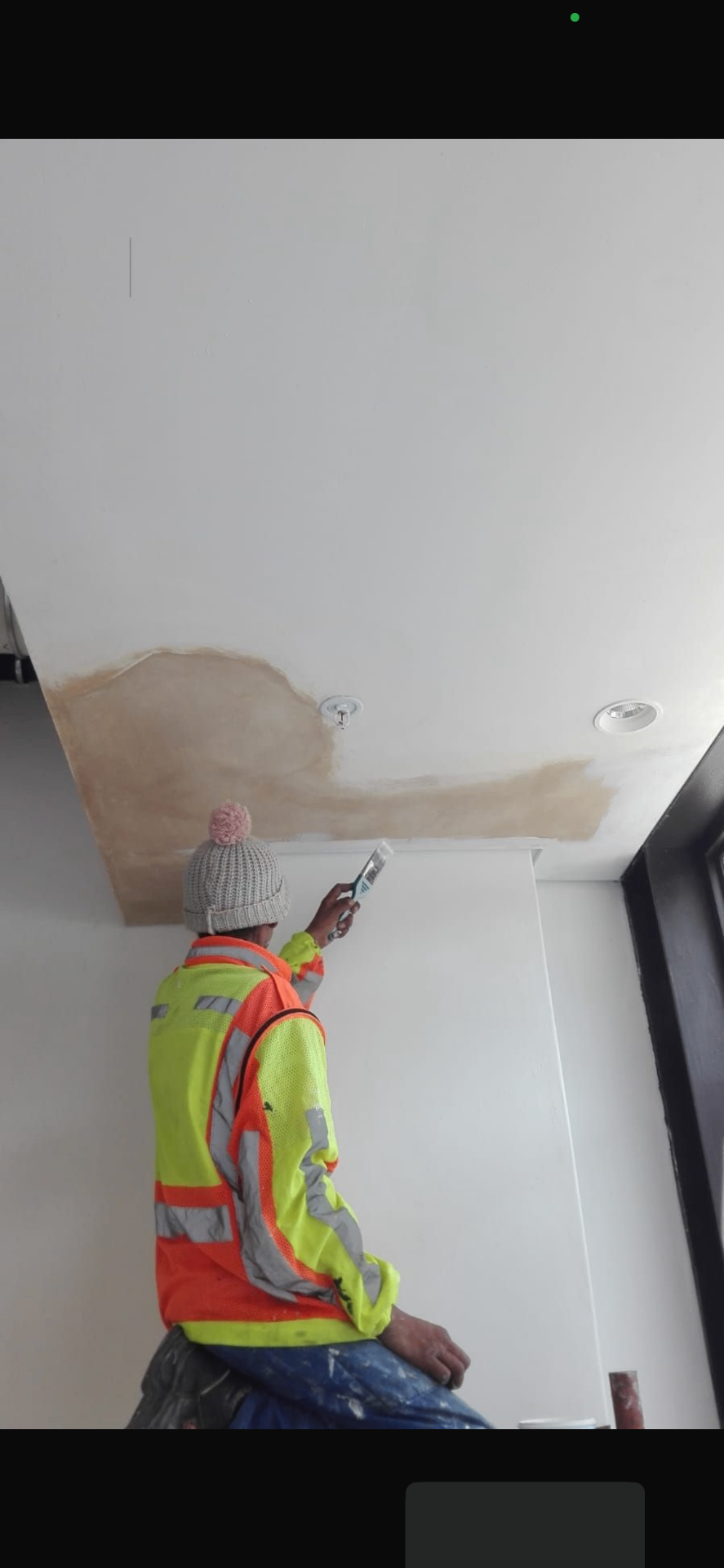 Technician identifying ceiling leak area